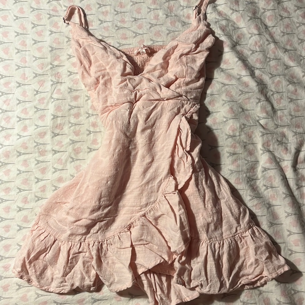 Pink sundress with cross over top piece, ruffled back,ruffle on bottom crossover
